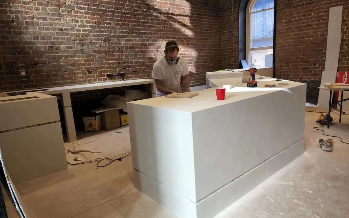 Microcement being finished on a built surface